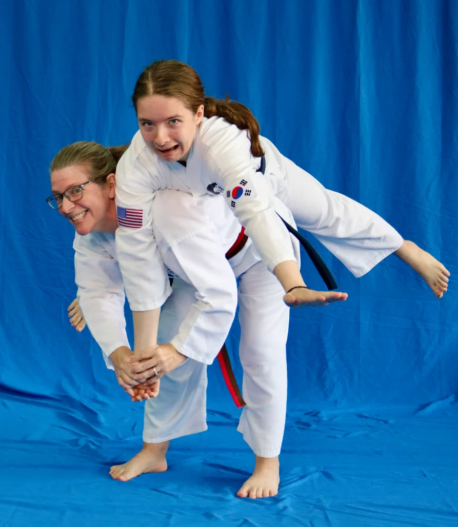 Adult martial arts instructor coaching student with focus mitts during fitness training in Newark gym